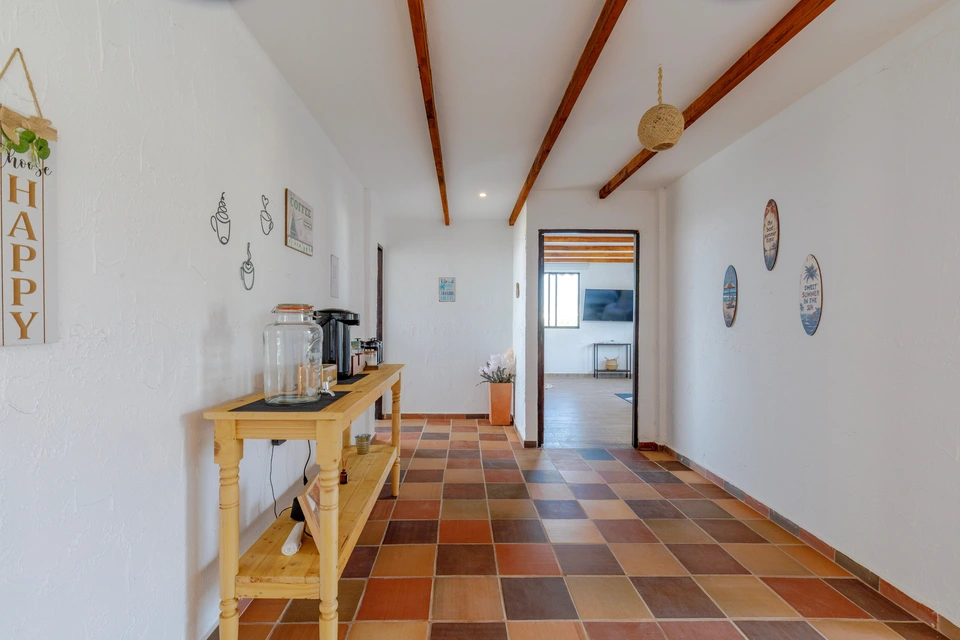 Bright interior hallway with exposed beams and coffee station