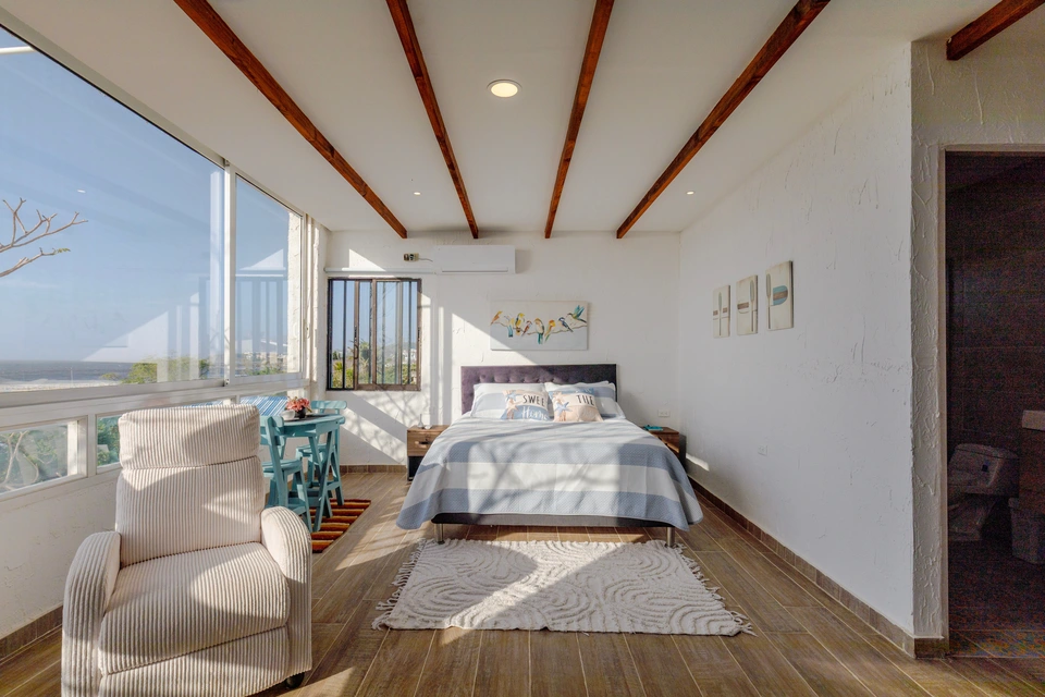 Room 4 chairs beside ocean-facing windows