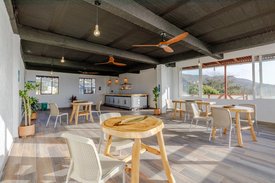 Wide view of the upstairs salon with flexible seating and bar